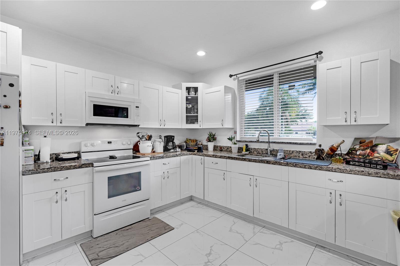 20825 Southwest 242nd Street Homestead, FL 33031 - Photo 33 of 52 a kitchen with white cabinets sink and appliances