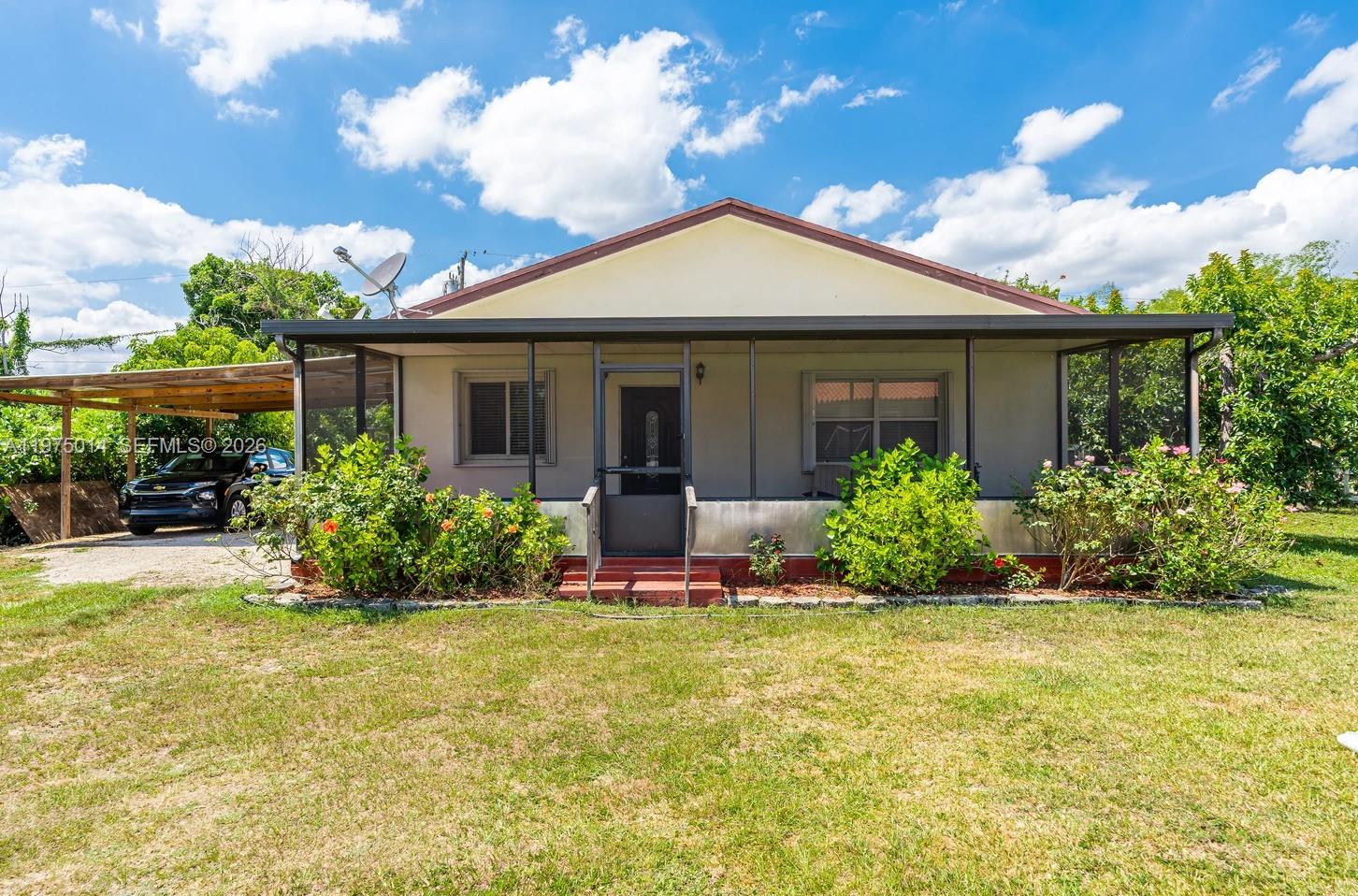20825 Southwest 242nd Street Homestead, FL 33031 - Photo 40 of 52 a front view of a house with a yard