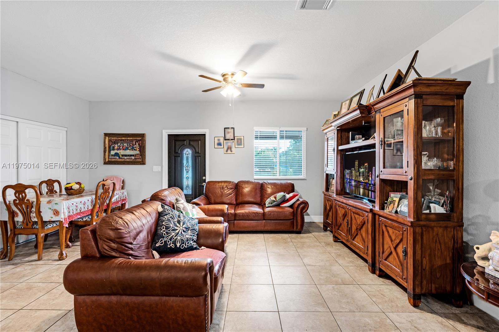 20825 Southwest 242nd Street Homestead, FL 33031 - Photo 43 of 52 a living room with furniture a window and a book shelf