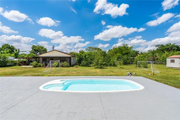 a view of a swimming pool with a yard