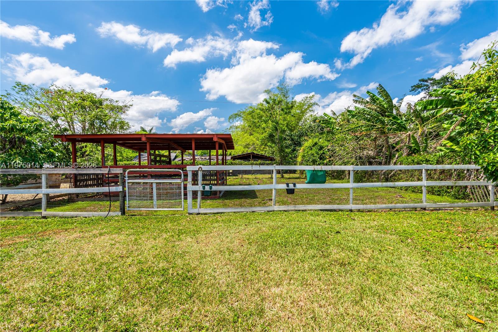 20825 Southwest 242nd Street Homestead, FL 33031 - Photo 48 of 52 a view of a swimming pool with a garden