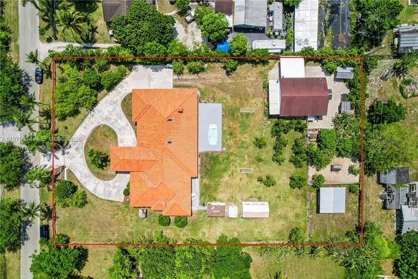 an aerial view of a house with outdoor space pool seating area and yard