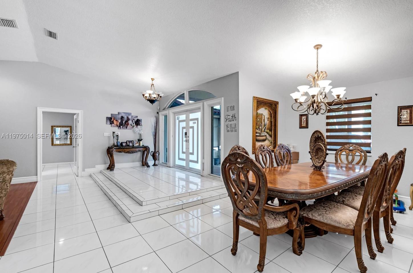 20825 Southwest 242nd Street Homestead, FL 33031 - Photo 9 of 52 a view of a dining room with furniture and chandelier
