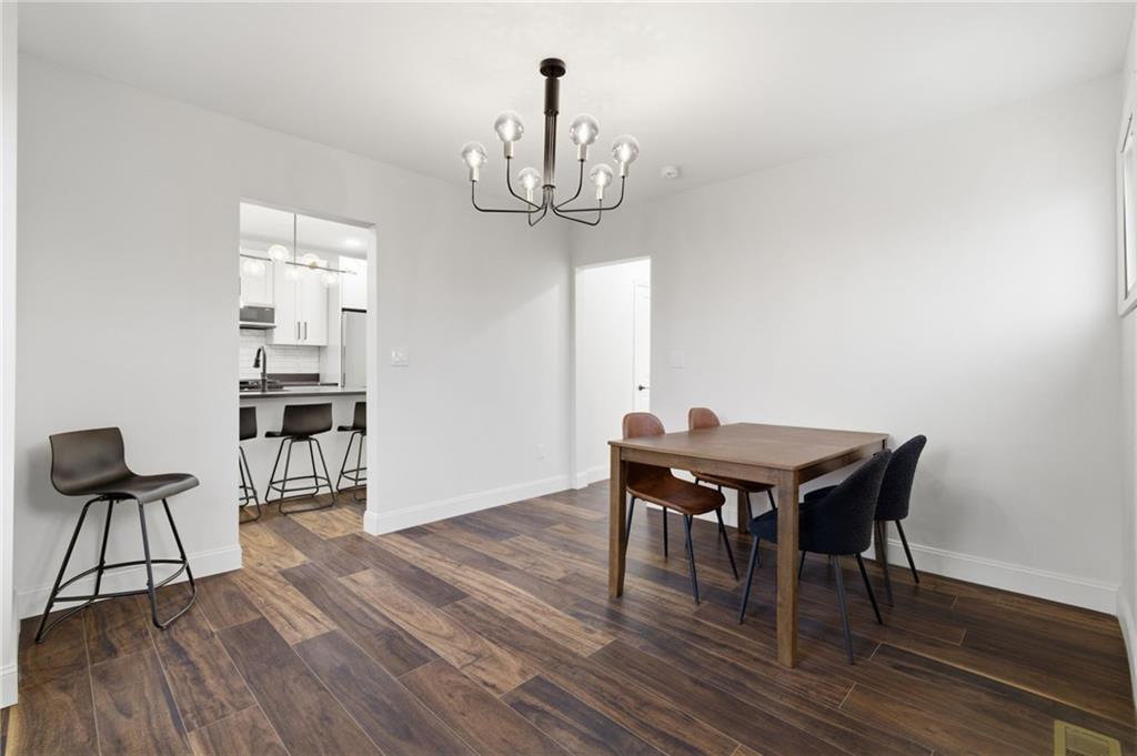 3 3rd Avenue Braddock, PA 15104 - Photo 14 of 46 a dining room with furniture a chandelier and wooden floor