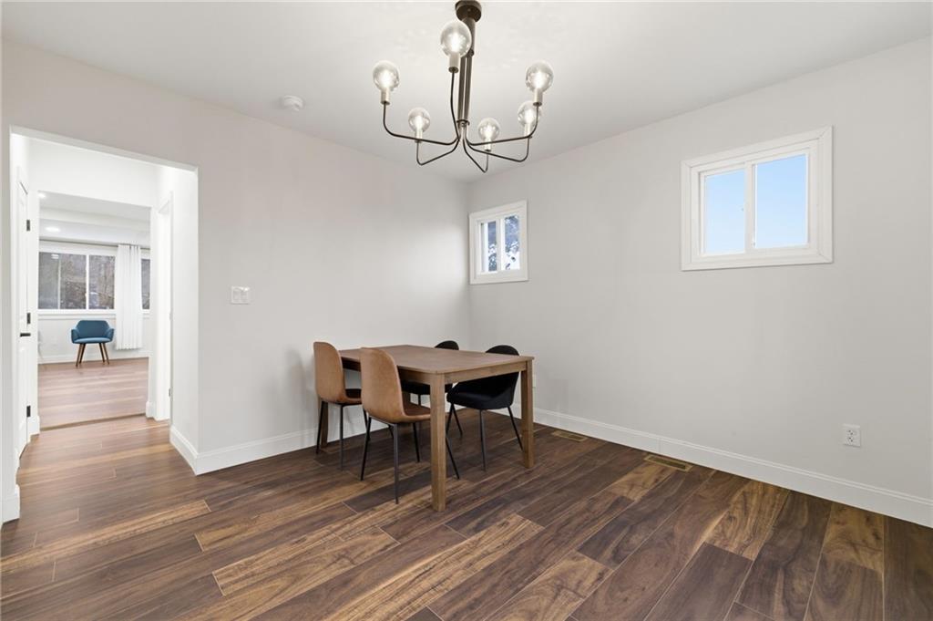 3 3rd Avenue Braddock, PA 15104 - Photo 15 of 46 a view of a dining room with wooden floor a chandelier a wooden table and chairs