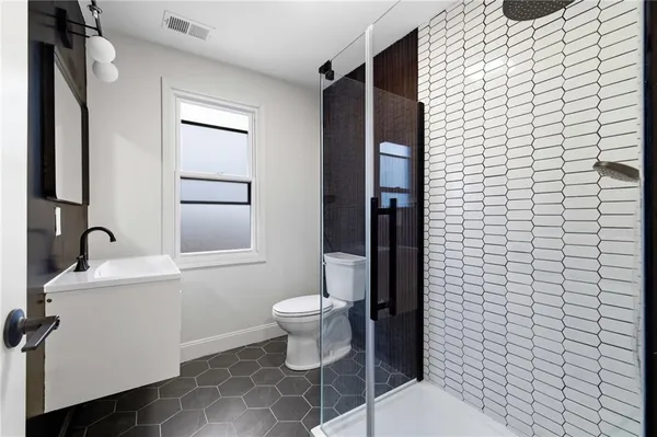 a bathroom with a sink toilet and shower