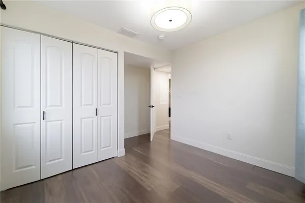 an empty room with wooden floor