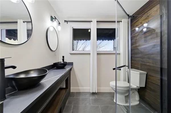 a bathroom with a toilet a sink and mirror