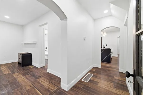 a view of a room with wooden floor and bathroom