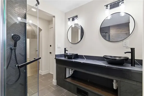 a bathroom with a double vanity sink and a mirror