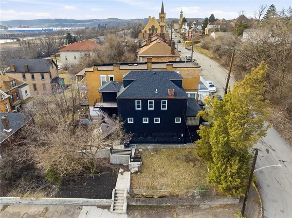 a aerial view of a house with a yard
