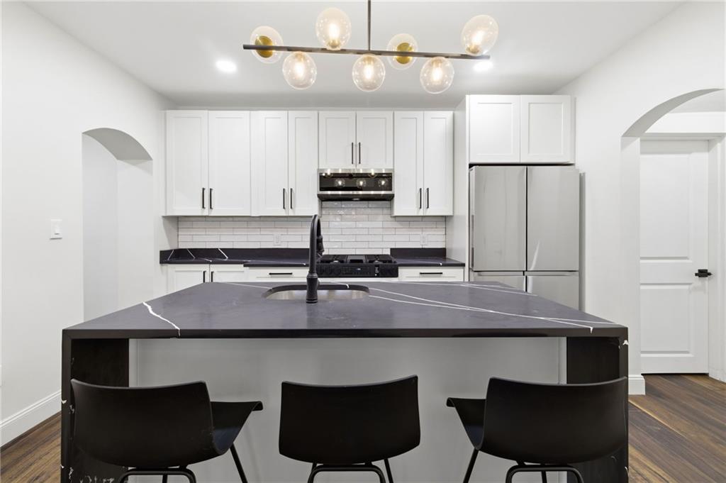 3 3rd Avenue Braddock, PA 15104 - Photo 6 of 46 a kitchen with a table chairs stove and cabinets