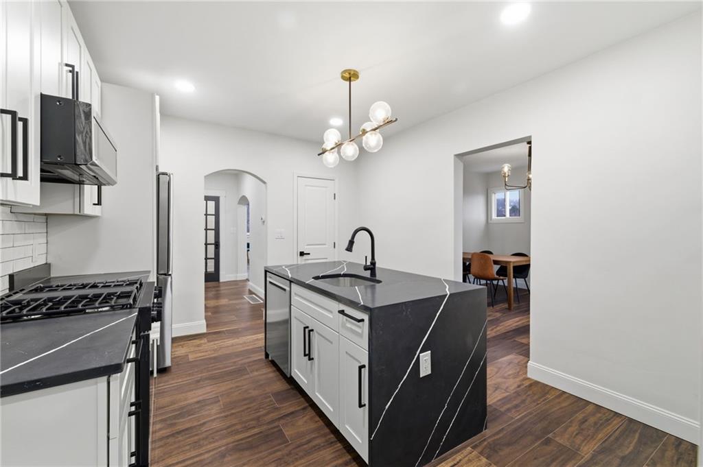 3 3rd Avenue Braddock, PA 15104 - Photo 7 of 46 a kitchen with stainless steel appliances granite countertop a stove a sink and a refrigerator