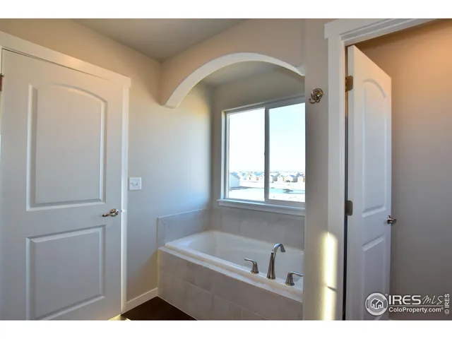a bathroom with a bathtub a shower and a vanity