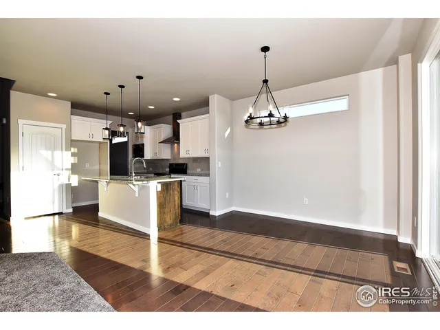 a view of a kitchen with wooden floor