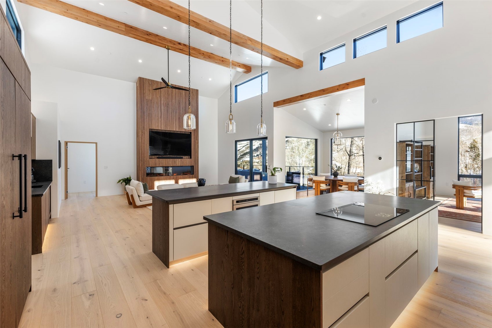 149 Game Trail Road Silverthorne, CO 80498 - Photo 14 of 49 Kitchen with a center island, high vaulted ceiling, beamed ceiling, light hardwood / wood-style floors, and black electric stovetop