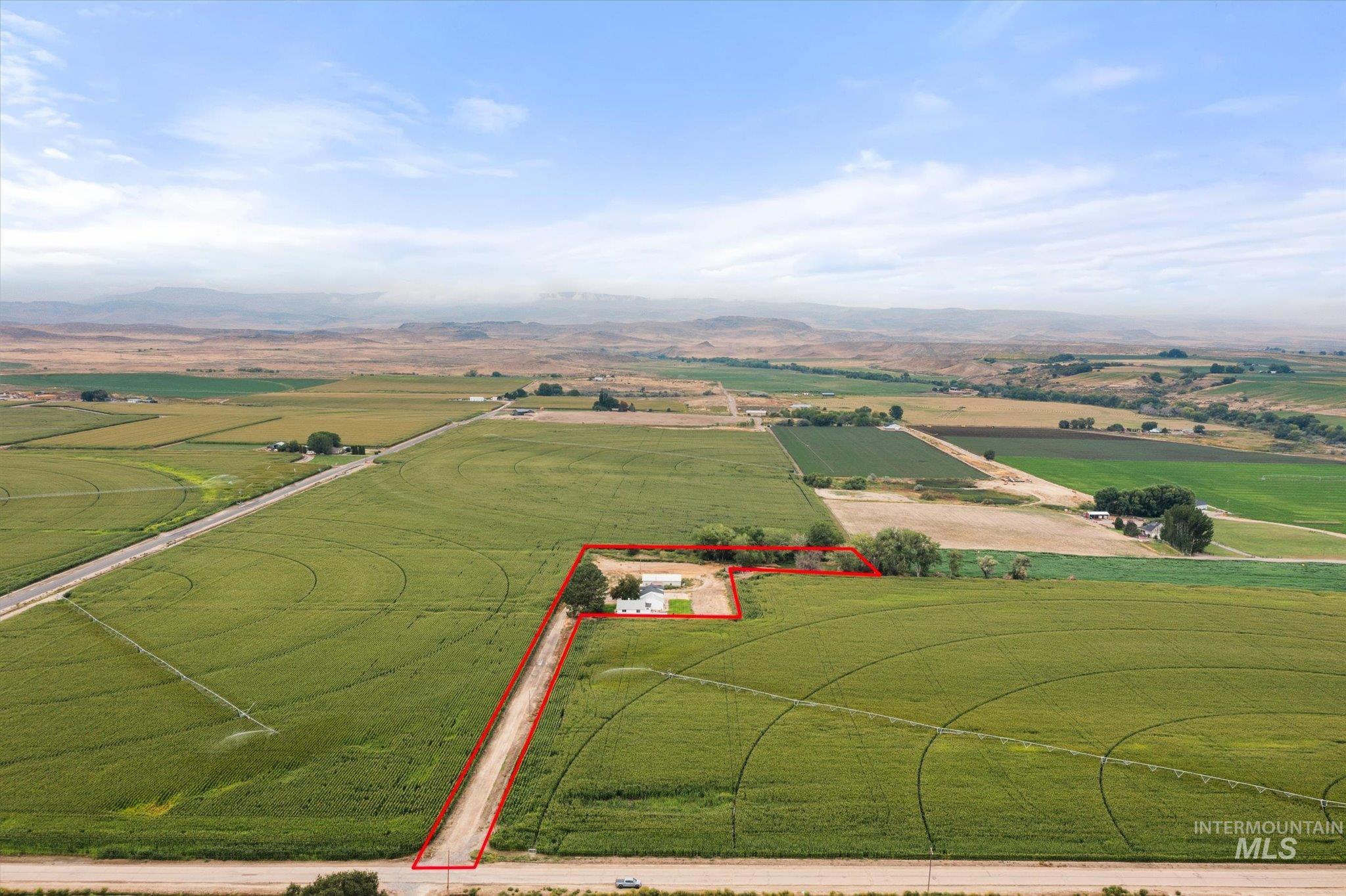 4173 Sage Road Homedale, ID 83628 - Photo 1 of 1 View of rural area featuring property boundaries highlighted, mountains, and rows of crops