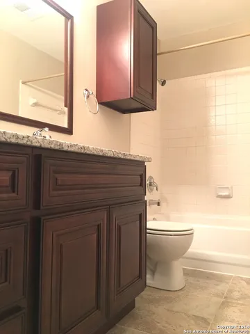 a bathroom with a toilet a sink and a mirror