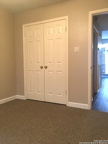 a view of a patio with a table and chairs