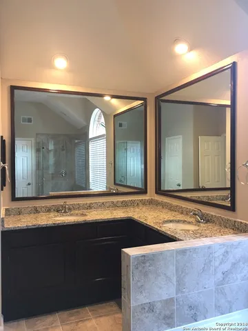 a view of a bathroom with a sink and mirror