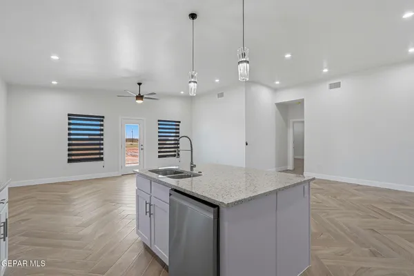 a kitchen with kitchen island a oven a chimney and a counter top space