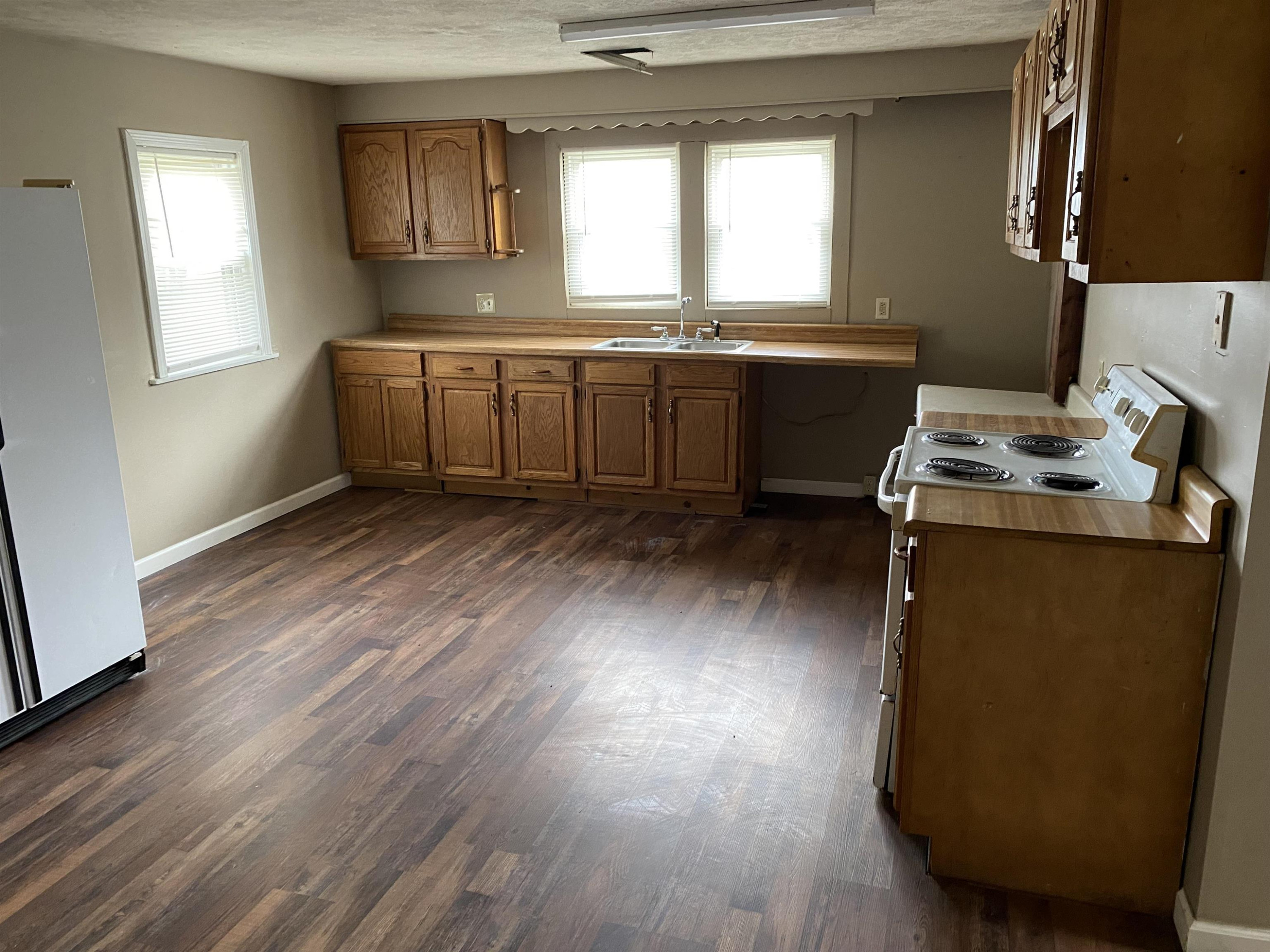 402 West Mill Street Rutherford, TN 38369 - Photo 2 of 5 a kitchen with wooden cabinets and sink