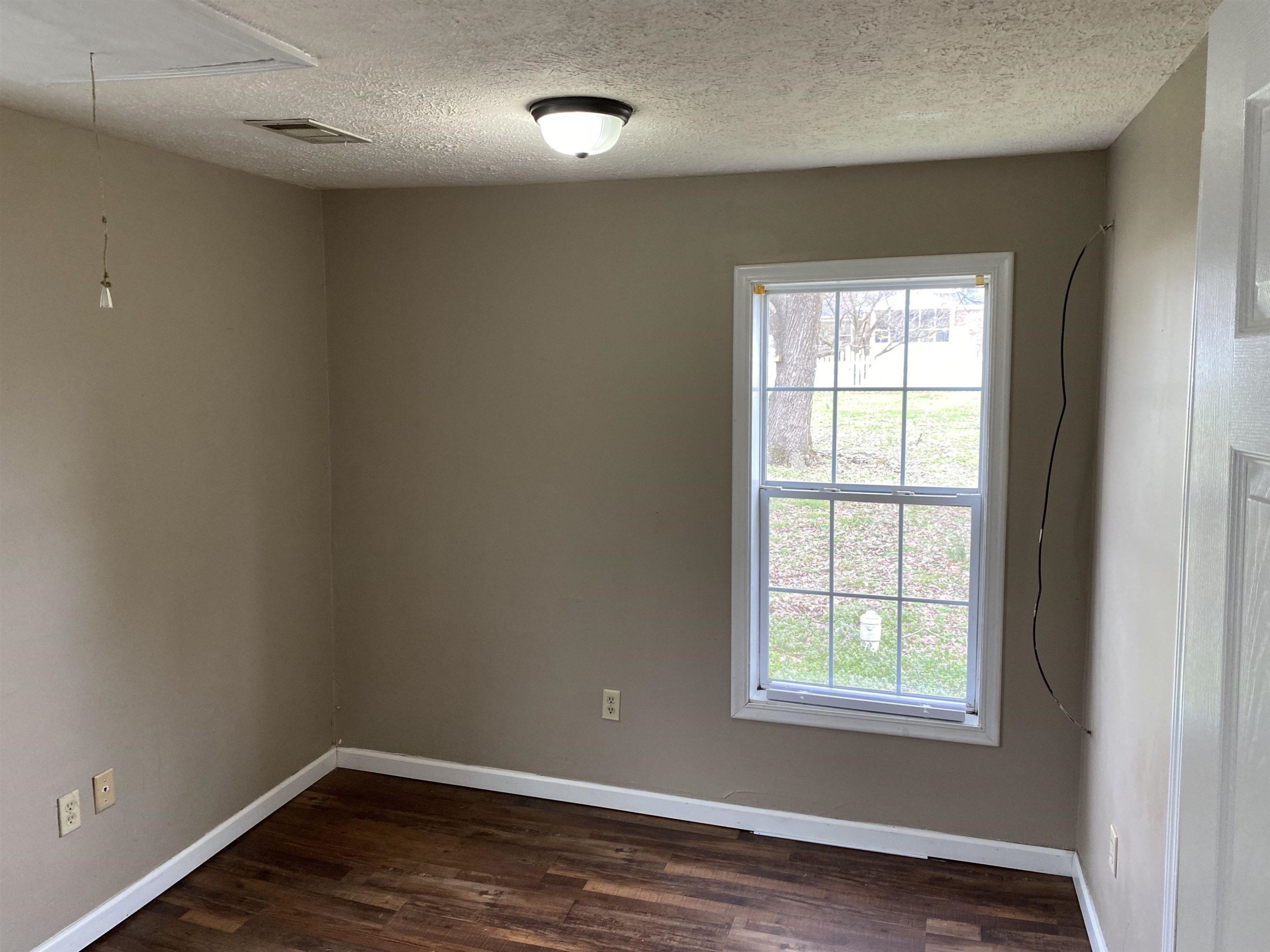 402 West Mill Street Rutherford, TN 38369 - Photo 5 of 5 an empty room with wooden floor and windows
