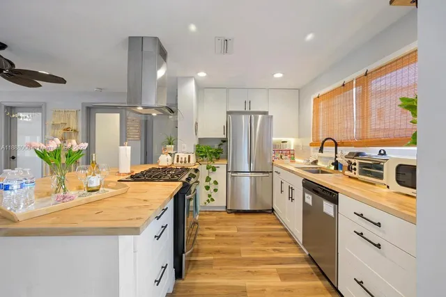 a kitchen with a sink stainless steel appliances and refrigerator