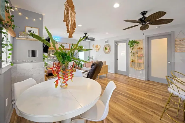 a view of a dining room with furniture and a chandelier