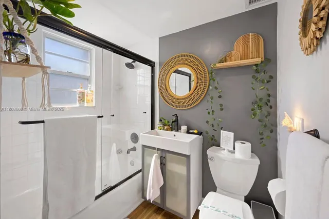 a bathroom with a toilet a sink and a mirror