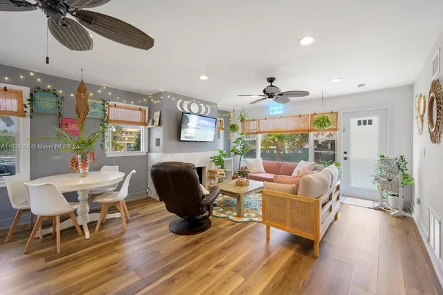 a living room with furniture fireplace and large windows
