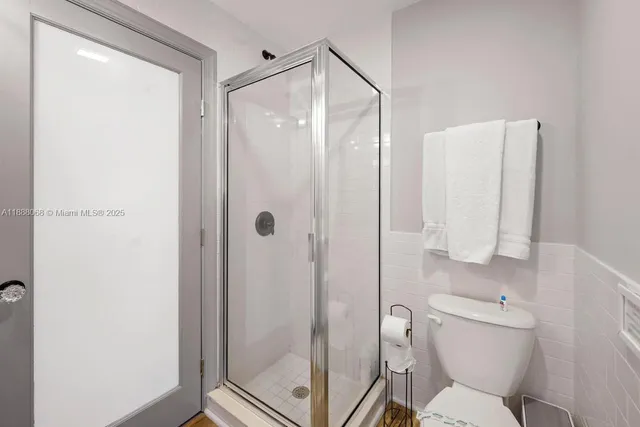 a bathroom with a shower and toilet