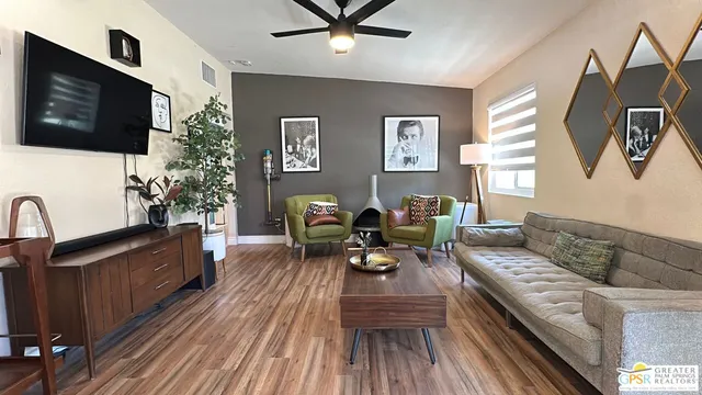 a living room with furniture fireplace and flat screen tv