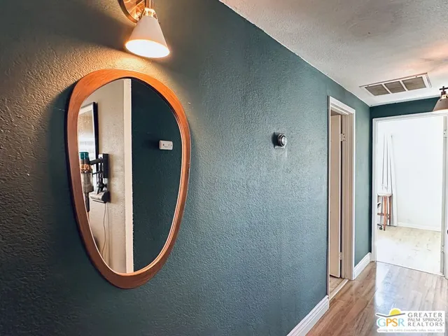 a view of a entryway door with wooden floor