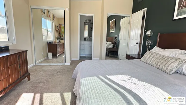 a bedroom with a bed and a mirror