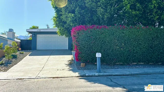 a pathway of a house with a yard