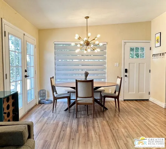 a dining room with furniture and wooden floor