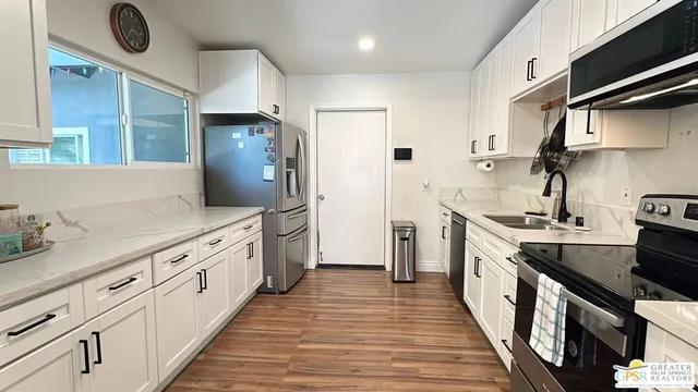 a kitchen with stainless steel appliances granite countertop a stove and a refrigerator
