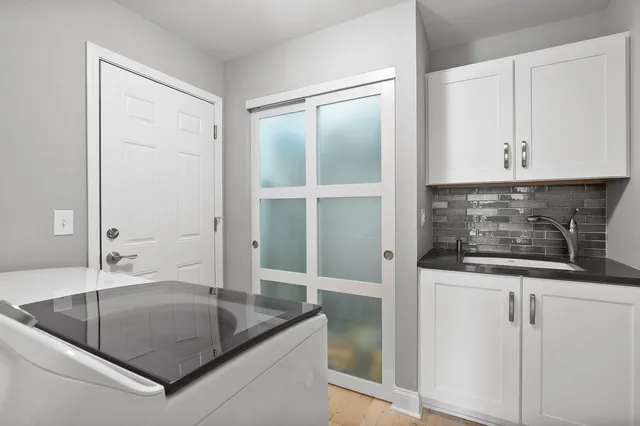 a living room with furniture a fireplace and a large window