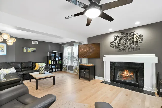 a living room with furniture a large window and a fireplace
