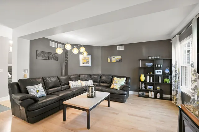 a bedroom with a bed a couch and a chandelier