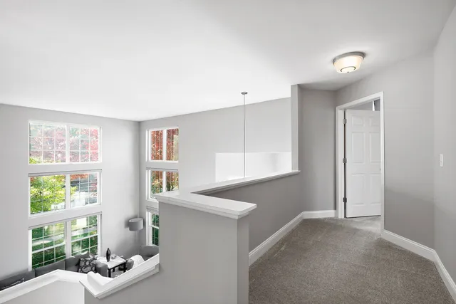 a bathroom with a double vanity sink a large mirror a bathtub and next to a window