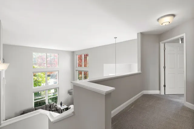a bathroom with a tub sink double vanity granite and a window