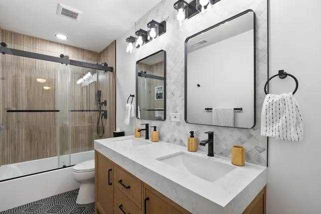 a view of a backyard with plants and large tree