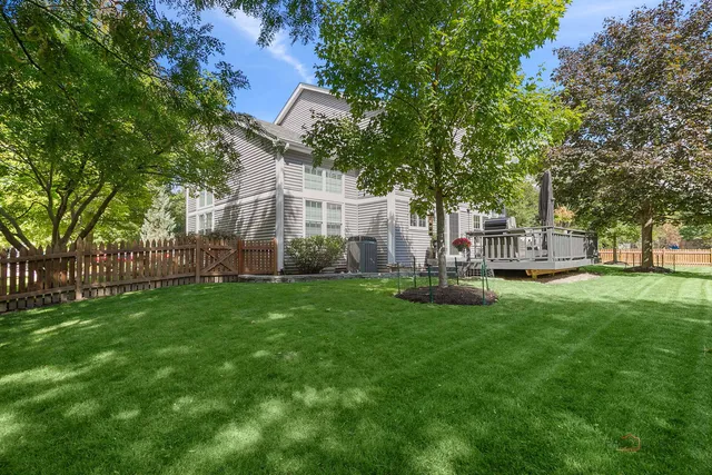 a view of a house with a yard and sitting area