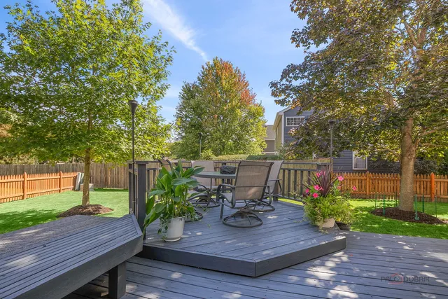 a view of a chairs in a back yard of the house