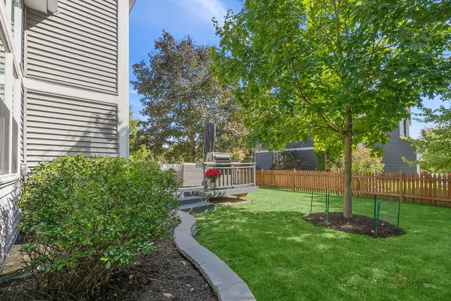a view of a deck with furniture and garden