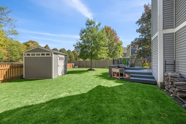 a view of a house with a yard and sitting area