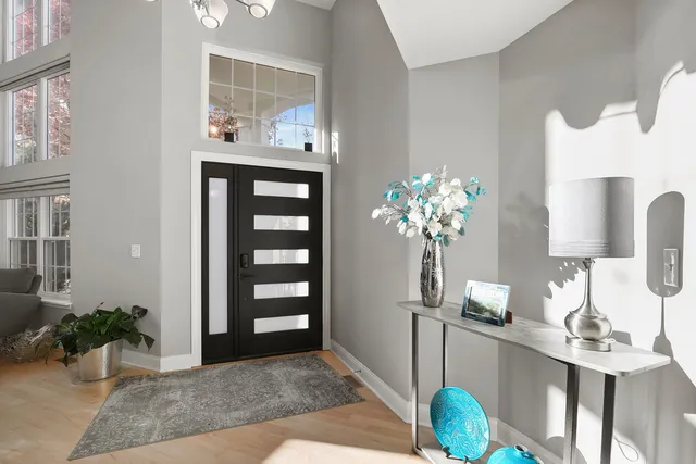 a view of entryway and hall with wooden floor