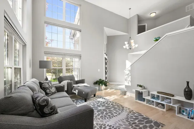 a bedroom with furniture and a large window